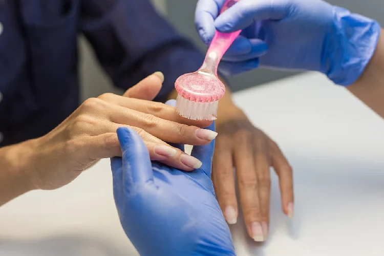 Nails Manicure. The manicurist will remove the coating with the apparatus. Hardware manicure.
